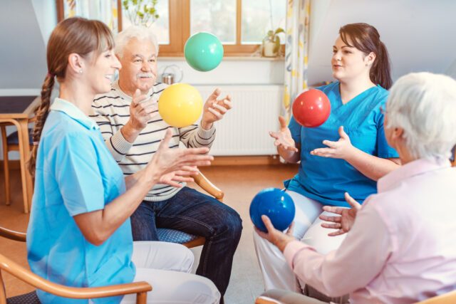 Group of seniors doing sport and gymnastics with balls